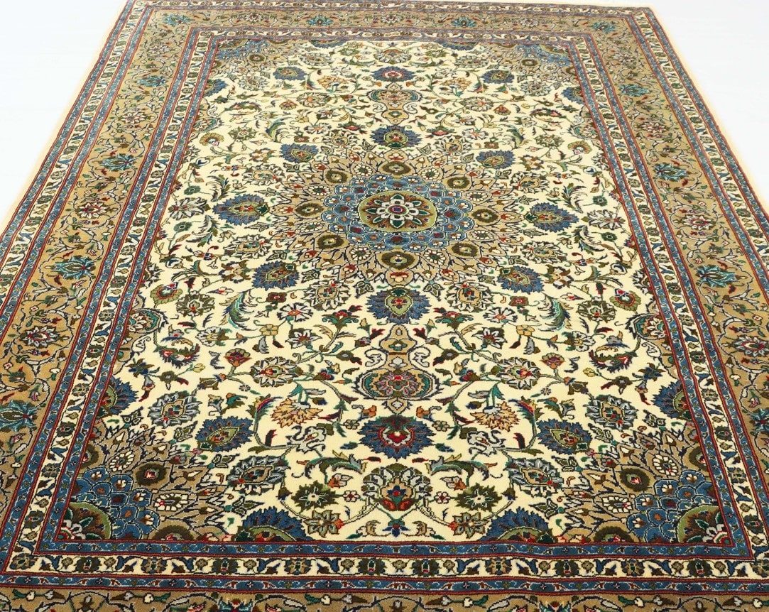 A close-up shot of a traditional Persian rug featuring an intricate design of flowers and leaves in shades of red, blue, and gold. The rug is made of wool and has a thick, luxurious texture.