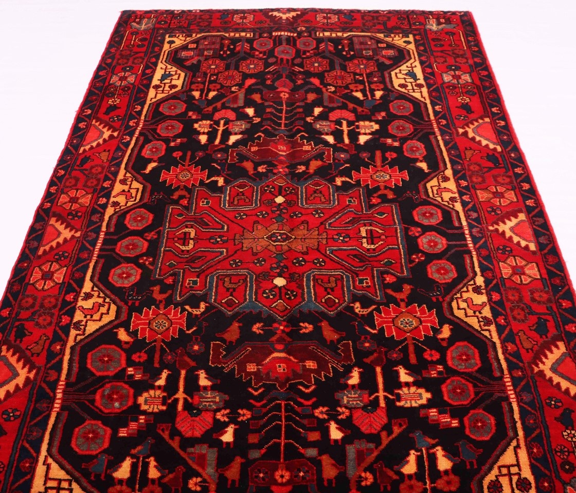 The picture is of a colorful, hand-woven tribal Persian rug with a geometric pattern, showcasing the unique craftsmanship and cultural significance of this style.