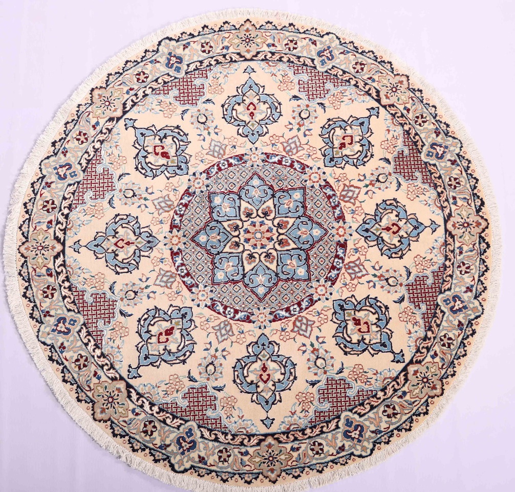 Round Persian rug featuring a central floral medallion surrounded by intricate patterns and borders. The rug is shown in a living room setting, with a neutral-colored couch and wooden coffee table providing a subtle backdrop for the vibrant rug. This image accompanies an article discussing the benefits of using round Persian rugs to add a unique touch to any room. These rugs come in a variety of sizes and colors and can serve as a statement piece or a complementary piece to other decor in living rooms, dining rooms, or bedrooms.